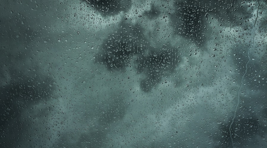 Rainwater flowing across pavement toward a storm drain during a heavy downpour