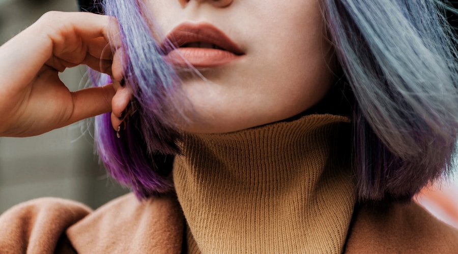 Hiking trail along a lakeshore with autumn foliage and blue water views